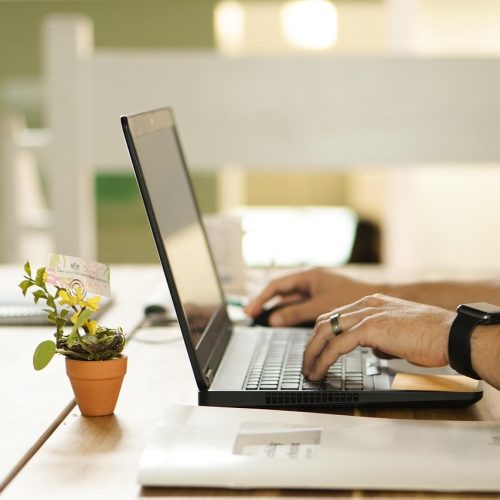 hands using laptop computer