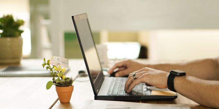 hands using laptop computer
